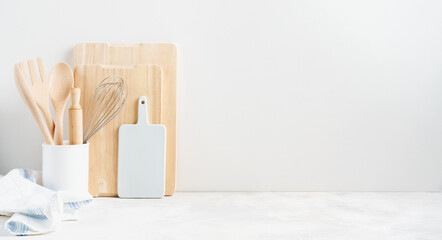 Kitchen background mockup with teepot and cooking, baking utensils rolling pin, cutboard, bowls on the table on white background. Blank space for a text, home kitchen decor concept.