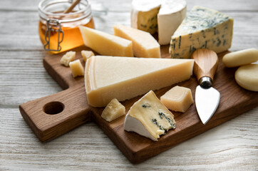 Various types of cheese  on a white wooden  background