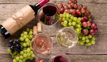 Variety Of Wine And Snack Set. Different Types Of Grapes. Fresh Ingredients On Wooden Background.