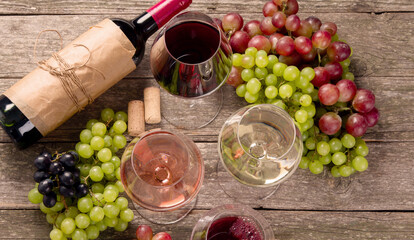 Variety of wine and snack set. Different types of grapes. Fresh ingredients on wooden background.