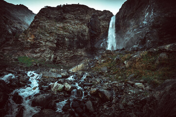 Russia, the Caucasus, Dombay, Big Sofrudjuksky (Sofrudjinsky) waterfall, powerful and high in the evening light, the dramatic landscape