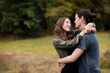 © Cavan Images - Couple embracing while standing on field