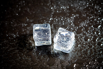 Wall Mural - ice cubes reflection on black table background.