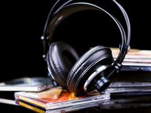 Black Hi-Fi Headphones On Some Music CDs