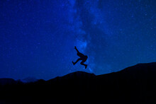Silhouette Jumping Under Milky Way Night Stars Extreme Creative Concept