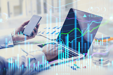 Poster - Businessman analyzing stock market graph chart, side view of stock trader using laptop and smart phone to buy or sell stock, double exposure graph, internet trading concept