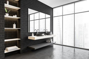 Black brick bathroom with two sinks, shelves, mirror and big window