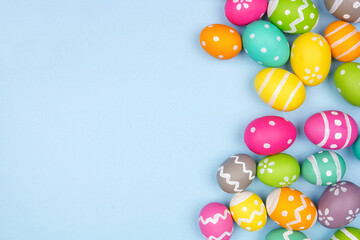 Poster - Colorful Easter Egg side border over a pastel blue paper background. Copy space.