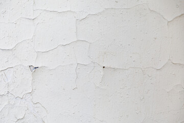 Wall Mural - texture of a white old wall with cracks and peeled paint