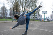 © Cavan Images - Flexible street dancer practicing freestyle dance