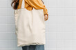 Leinwandbild Motiv Woman is holding tote bag canvas fabric for mockup blank template.