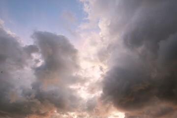 Clear blue sky with glowing pink and golden cumulus clouds after storm at sunset. Dramatic cloudscape. Meteorology. Heaven, hope, peace concept. Graphic resources, copy space. Picturesque scenery