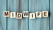 Midwife Word Written In Wooden Cube on wooden background