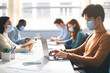 © Prostock-studio - International people wearing medical masks using laptop