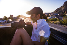 Young Smiling Woman Capturing Landscapes Using DSLR Camera From Car