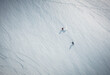 © Cavan Images - Two men skiing on snow in Iceland from overhead angle