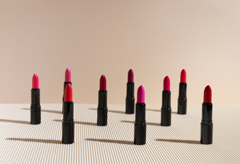 lipstick in different shades of red and pink colors on a corrugated background