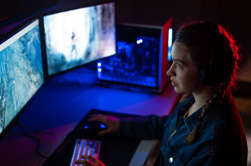 professional gamer playing online first person shooter on his personal computer. lighting neon light