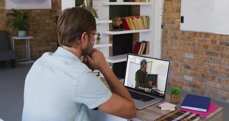 Canvas Print - Caucasian male student using laptop on video call with male teacher