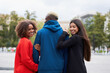 © Andrii - Multi ethnic friends outdoor. Two woman in love with one guy Diverse group people Afro american asian spending time together Multiracial male female student walking park outdoors