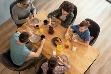 Poster - Overview of contemporary family of five having breakfast by served dinner table