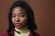 © Seventyfour - Close up portrait of real African American woman looking at camera while posing against neutral background in studio with focus on skin imperfections, copy space