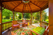 View Of A Wooden Gazebo In The Landscaped Garden Of An Upscale Home.