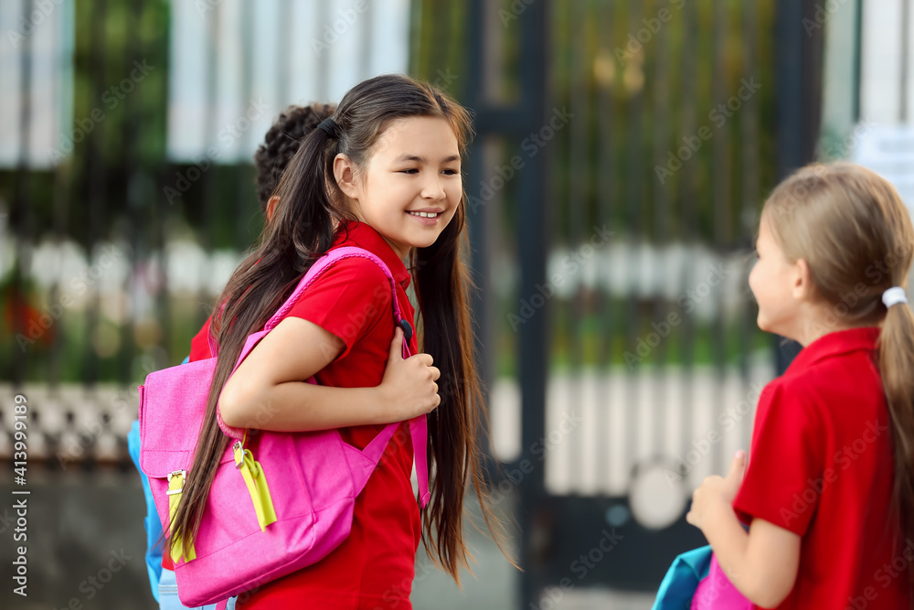 Cute little pupils going to school