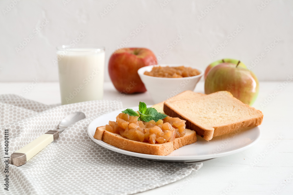 Toast with sweet apple jam in plate on light background