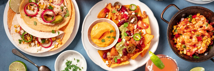 mexican food panoramic header on a blue background. nachos with chili con carne, tacos with chicken,