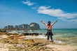 © Noppasinw - Tropical islands view with woman tourist looking at ocean blue sea water and white sand beach at Bamboo Island, Krabi Thailand nature landscape