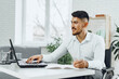 © fotofabrika - Positive disabled young man in wheelchair working in office