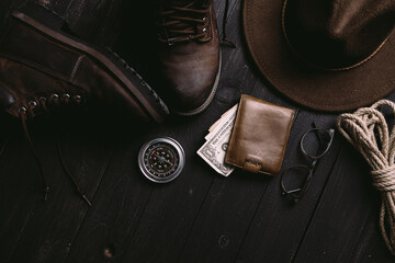 Flat lay of travel things on vintage wooden desk