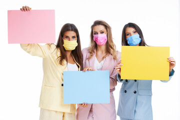 Poster - Three women in pastel suits holding billboard posing over white background