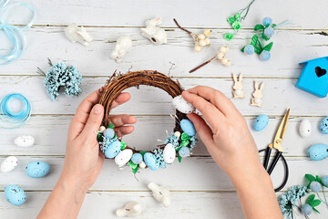 handmade diy home interior decoration wreath with easter eggs in blue and white colors