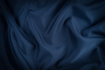 Bright blue fabric texture with folds.