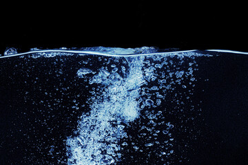 Water splash in aquarium isolated on black background