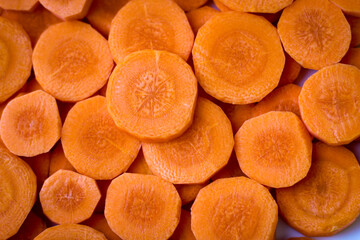 Wall Mural - Delicious food background. Raw carrots cut into mugs