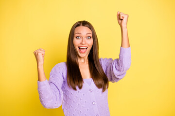 Wall Mural - Portrait of attractive cheerful girl rejoicing having fun great luck isolated over bright yellow color background