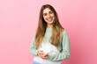 © luismolinero - Young woman over isolated pink background laughing