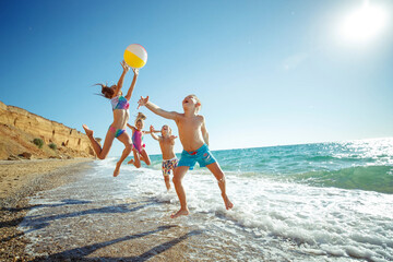 Cute kids having fun on the sandy beach in summer. High quality photo.