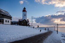 Snow Covered Beach During Wnter By Urk Lighthouse In The Netherlands. Cold Winter Weather In The Netherlands