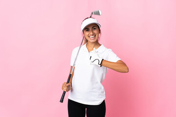 Wall Mural - Young hispanic woman over isolated pink background playing golf and with thumbs up because something good has happened