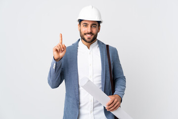 Wall Mural - Young architect man with helmet and holding blueprints isolated on white background pointing up a great idea