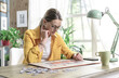 © StockPhotoPro - Woman sitting at desk and solving a puzzle