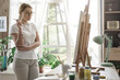 © StockPhotoPro - Woman looking at her artwork in the studio