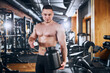 © Viacheslav Yakobchuk - Smiling young bodybuilder taking supplements in gym