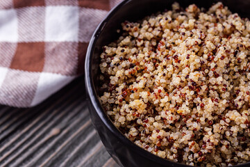 bowl of healthy quinoa on a dark wooden rustic background