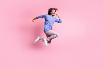 Wall Mural - Full size photo of young attractive smiling cheerful excited positive man jump fly run isolated on pink color background