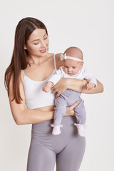 Wall Mural - Loving young European mother hold little newborn infant child, enjoying moment together, caring mom embrace small baby toddler, maternity, childcare, isolated over white background.